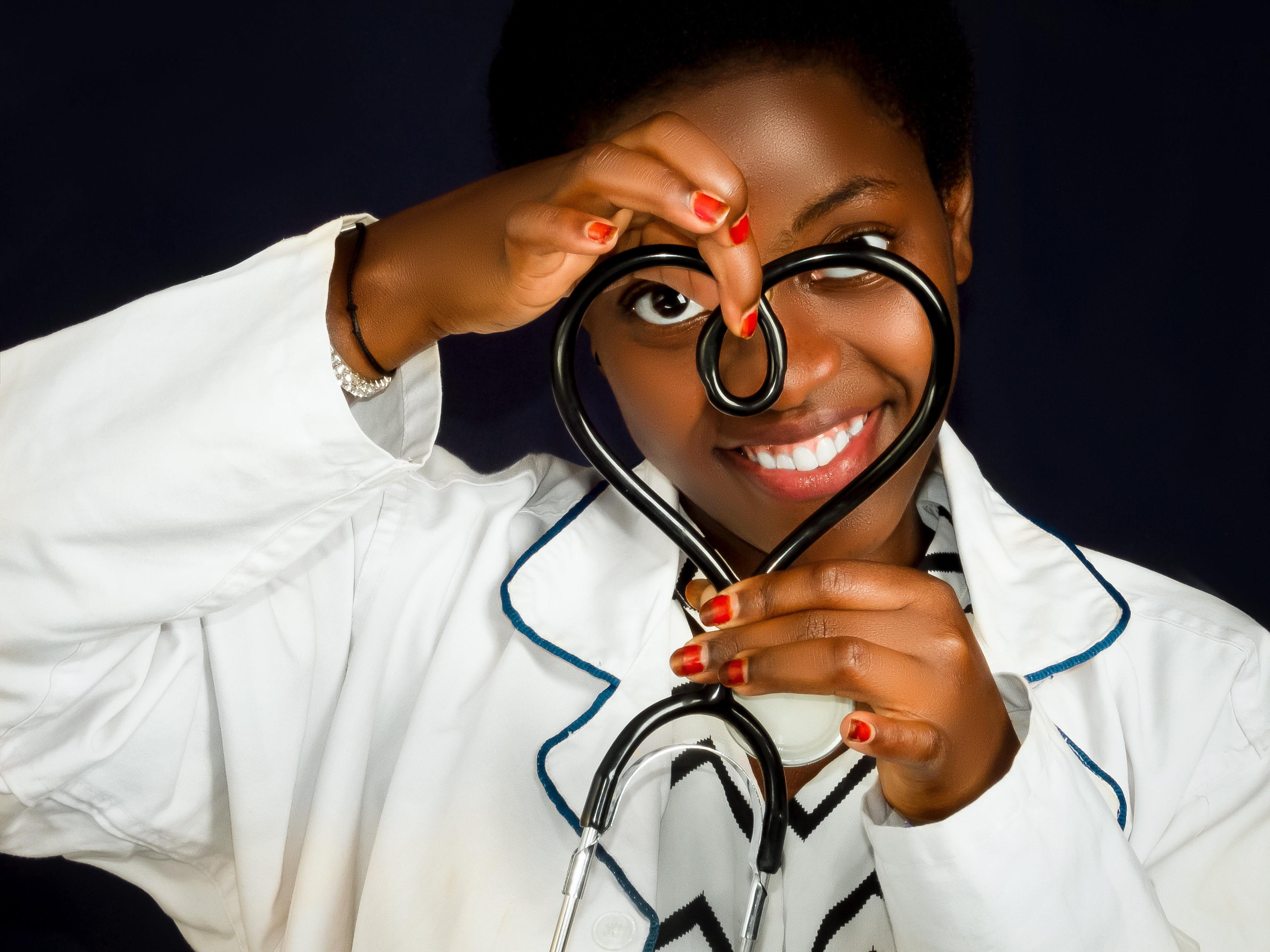 A doctor forming a heart shape with her stestoscope